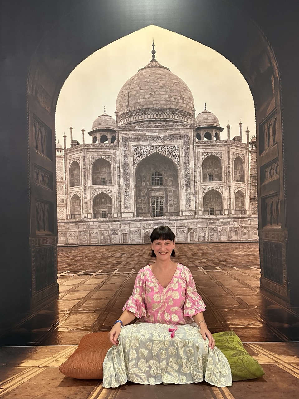 Birgit sitzend vor einem Taj Mahal Motiv
